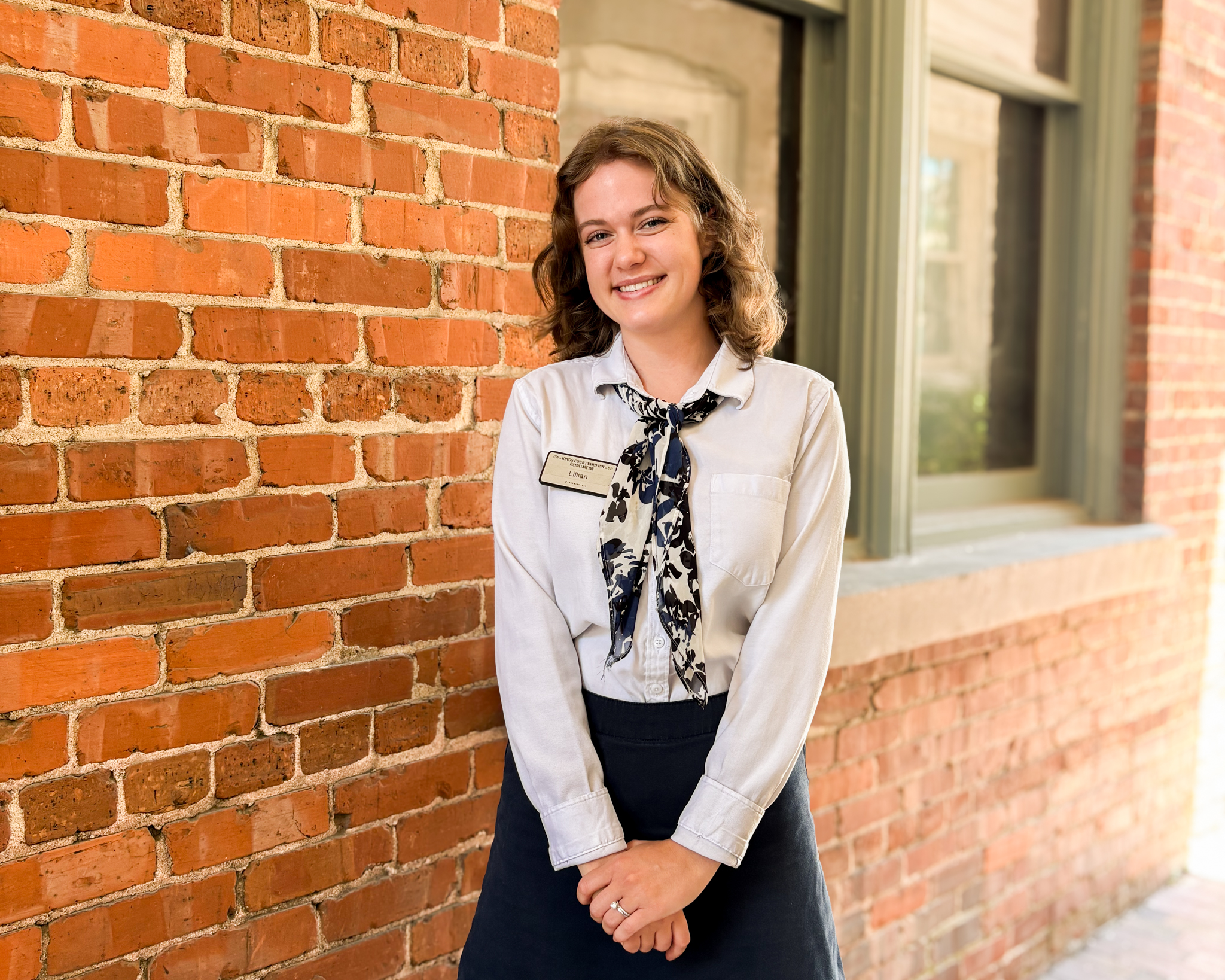 Concierge Lillian Nance standing by Fulton Lane Inn